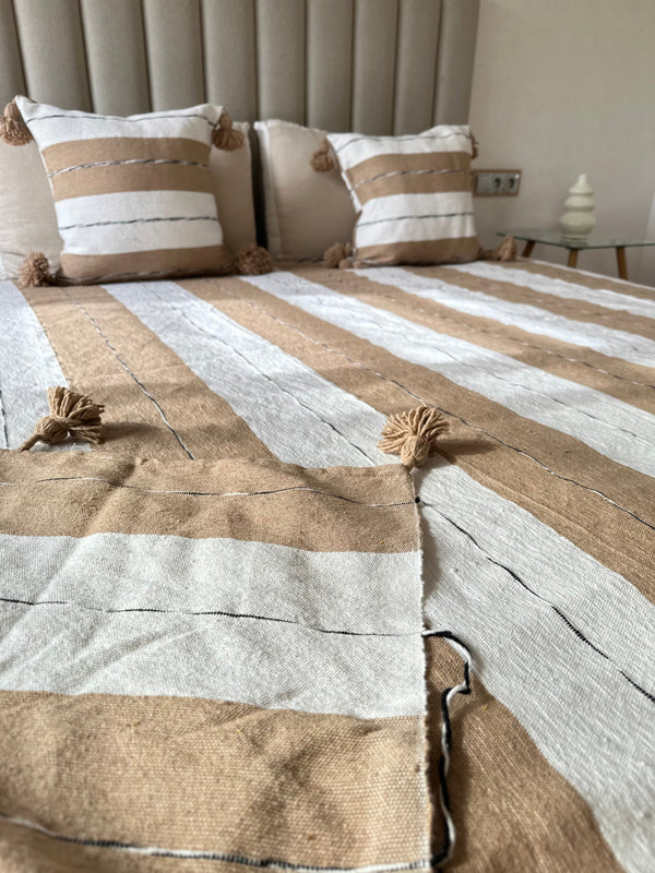 Handmade printed throw with beige, white, and black pompoms 110" x 79"