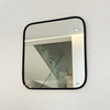 Square mirror in black brass