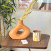 Light orange striped handmade terracotta candle with Amber scent