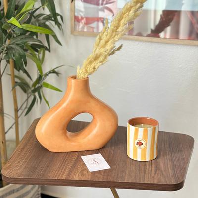 Light orange striped handmade terracotta candle with Amber scent