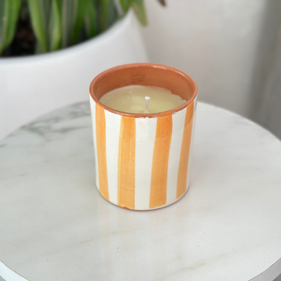 Light orange striped handmade terracotta candle with Amber scent