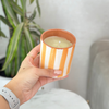 Light orange striped handmade terracotta candle with Amber scent