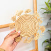Natural raffia saucer with pompoms