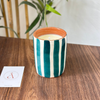 Handmade petroleum blue striped terracotta candle with orange blossom scent
