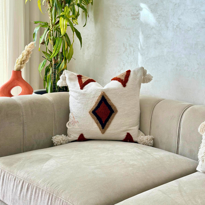 Handmade cushion cover with terracotta pompoms
