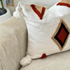 Handmade cushion cover with terracotta pompoms