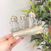 Set of 3 glass bottles with silver-plated brass holder for bathroom