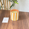 Light orange striped handmade terracotta candle with Amber scent