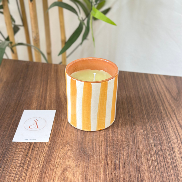 Light orange striped handmade terracotta candle with Amber scent