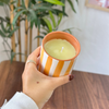 Light orange striped handmade terracotta candle with Amber scent