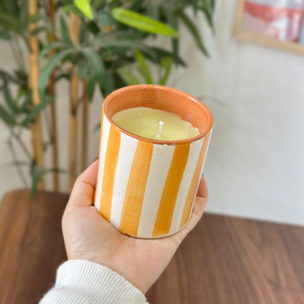 Light orange striped handmade terracotta candle with Amber scent